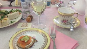 Photos shows smoked salmon sandwiches on a vintage china plate