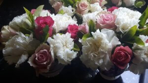 Roses and Carnations in pretty tea cups make a lovely centre piece for your table