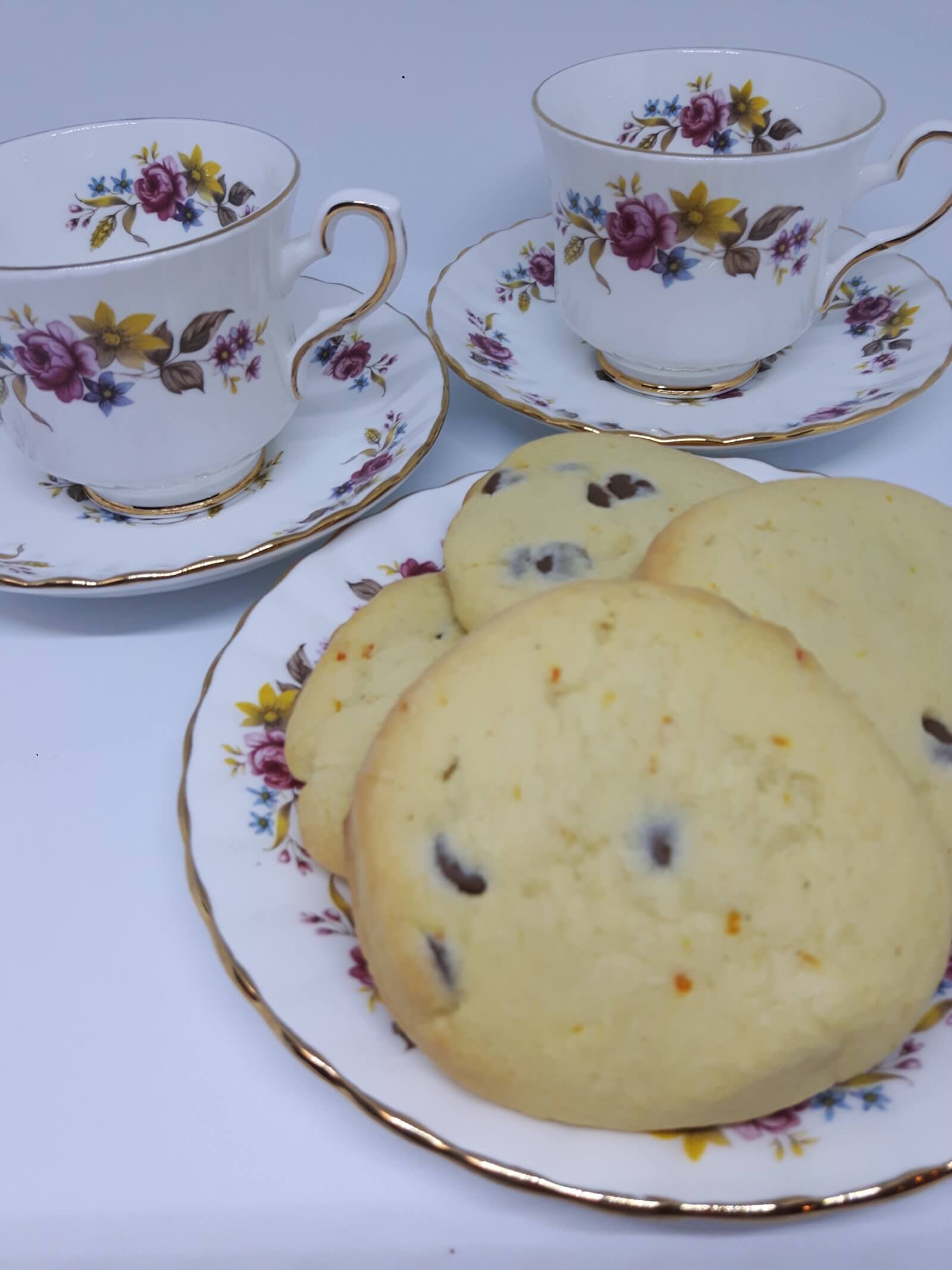 A plate with Chocolate Orange Shortbread and 2 Vintage Tea Cups